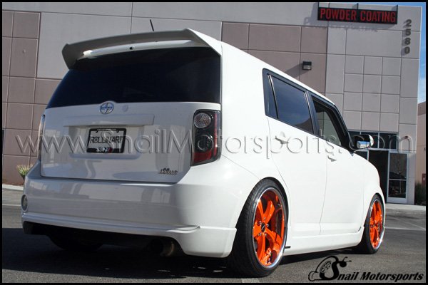 Scion xB with three piece Metallic Orange wheels